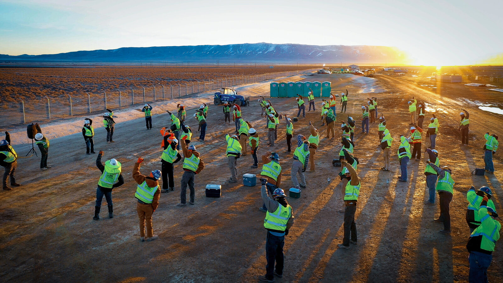 Group of ͵E Energy employees stretching prior to work